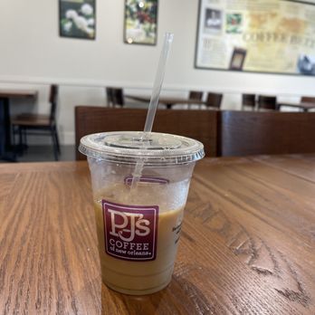 PJ's Coffee - a cup of coffee on a table - Coffee & Tea Near Me - Pensacola, Florida PJ's Coffee - a cup of coffee on a table - Coffee & Tea Near Me - Pensacola, Florida