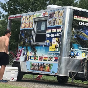 Caribbean Jerk Pot - a man standing next to a food truck - Food Trucks Near Me - Lynchburg, Virginia