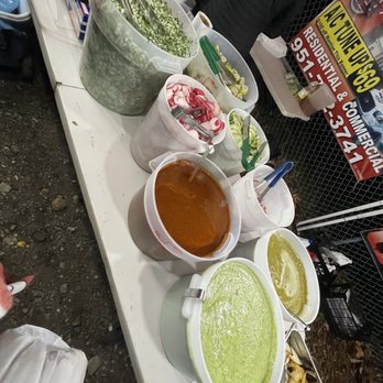 Tacos Santa Cruz - a variety of condiments on a table - Food Stands Near Me - Fontana, California Tacos Santa Cruz - a variety of condiments on a table - Food Stands Near Me - Fontana, California