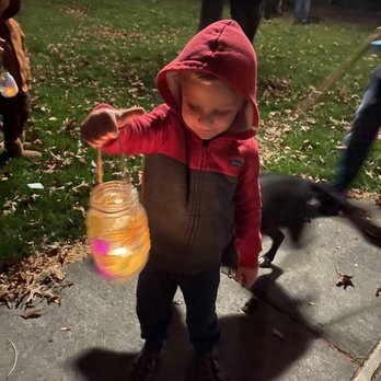 A Child’s Garden - Lantern Walk and food drive event. D holding the lantern he made in class. - Preschools Near Me - Bend, Oregon