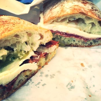 Salumi - On left: Mole Sandwich with fresh mozzarella, peppers and onions. On right: Salumi Salami Sandwich with fresh Mozzarella - Italian Near Me - Seattle, Washington Salumi - On left: Mole Sandwich with fresh mozzarella, peppers and onions. On right: Salumi Salami Sandwich with fresh Mozzarella - Italian Near Me - Seattle, Washington