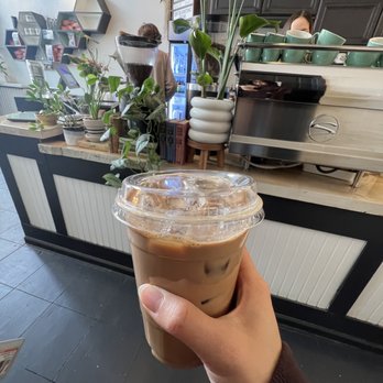 Tried & True Coffee - a hand holding a cup of iced coffee - Coffee & Tea Near Me - Corvallis, Oregon
