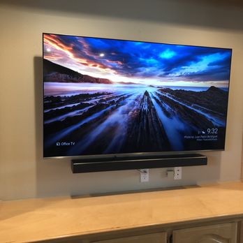 Bay Area Wall Mounts - Mounted TV with tilt mount and sound bar.  Ran wires through wall and down into cabinets. - Home Theatre Installation Near Me