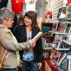 Revelstoke Railway Museum - Customer browsing our book selection in the Museum Store with the assistance of a Museum staff member.