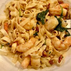 Mama Risos Restaurant - Homemade gluten-free pasta with shrimp, sun-dried, tomatoes, and spinach, in a white wine garlic sauce.
