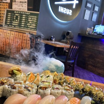 Koi Sushi - Godzilla roll, eel avocado roll, spider roll, salmon skin roll, assorted nigiri, and dramatic smoke - Japanese Near Me - Chicago, Illinois Koi Sushi - Godzilla roll, eel avocado roll, spider roll, salmon skin roll, assorted nigiri, and dramatic smoke - Japanese Near Me - Chicago, Illinois