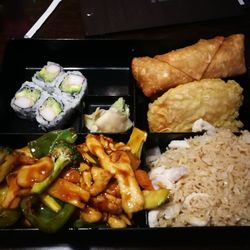 Ichiban Sushi & Chinese - New Hudson - Garlic chicken lunch box with sushi, egg row and fried sweet potatoes.