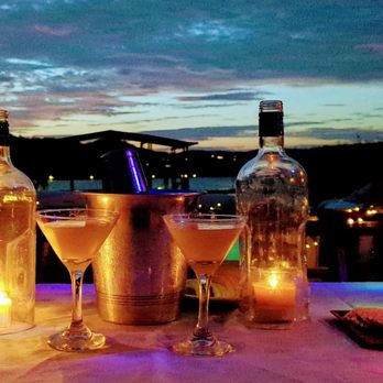 Floating Tavern - two glasses of champagne and a bottle of wine - Tapas/Small Plates Near Me - Austin, Texas Floating Tavern - two glasses of champagne and a bottle of wine - Tapas/Small Plates Near Me - Austin, Texas