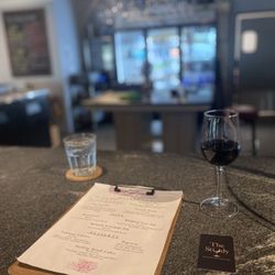 The Study - Bar area ft wine and menu (blurred background)