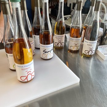 Crave Mead - a variety of bottles of wine on a counter - Meaderies Near Me - Blackstone, Massachusetts