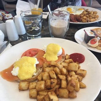 Evviva Breakfast & Lunch - Smoked salmon eggs benedict with home fries, a maple latte, sunny side up eggs with home fries, bacon, sausage and side of pancakes - Breakfast & Brunch Near Me - Vaughan, Ontario Evviva Breakfast & Lunch - Smoked salmon eggs benedict with home fries, a maple latte, sunny side up eggs with home fries, bacon, sausage and side of pancakes - Breakfast & Brunch Near Me - Vaughan, Ontario