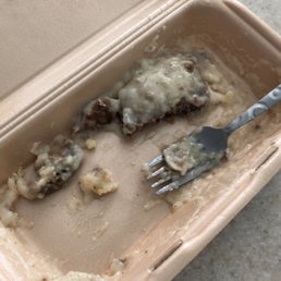 a partially eaten meal in a styrofoam container a partially eaten meal in a styrofoam container