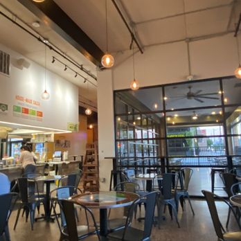 Tacodeli - a restaurant with tables and chairs - Tacos Near Me - Houston, Texas