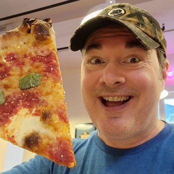 Zee’s Pizzeria - eating pizza slice - Pizza Near Me - New Orleans, Louisiana Zee’s Pizzeria - eating pizza slice - Pizza Near Me - New Orleans, Louisiana