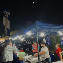 a group of people at a food stand