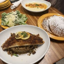 BLACKENED REDFISH, DIRTY RICE, SHRIMP GRITS and PANCAKES. Also SWEET POTATOES BEIGNETS not shown in the picture.