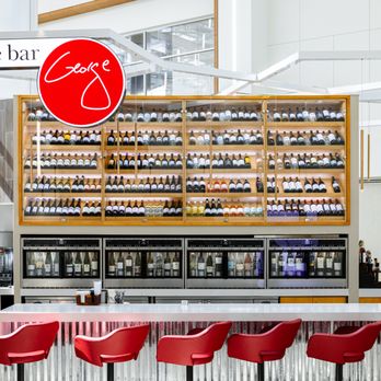 Wine Bar George at MCO - red chairs at the bar - Wine Bars Near Me - Orlando, Florida Wine Bar George at MCO - red chairs at the bar - Wine Bars Near Me - Orlando, Florida