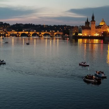 Karlův Most - View of Charles Bridge on a spring night with people paddling boats around and the Tower in the background ... - Landmarks & Historical Buildings Near Me - Prague, Puerto Rico