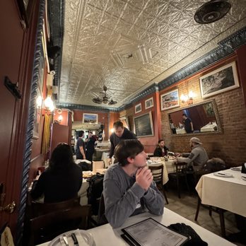 Lazzara's Pizza - a woman sitting at a table - Pizza Near Me - New York, New York Lazzara's Pizza - a woman sitting at a table - Pizza Near Me - New York, New York