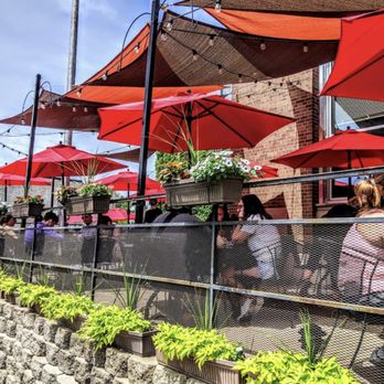Post - American Eatery - outdoor seating with red umbrellas - American Near Me - Hudson, Wisconsin Post - American Eatery - outdoor seating with red umbrellas - American Near Me - Hudson, Wisconsin