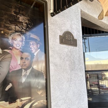 Dogfathers - a man and a woman in front of a building - Pizza Near Me - Parker, Arizona
