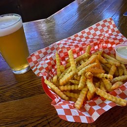 a basket of french fries and a pint of beer a basket of french fries and a pint of beer