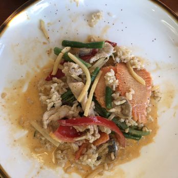 Wild Ginger - Red curry with pork and veggies with brown rice. - A white plate with a gold rim contains rice, vegetables, and a piece of salmon, with some food remnants and sauce. - Thai Near Me - Norwell, Massachusetts