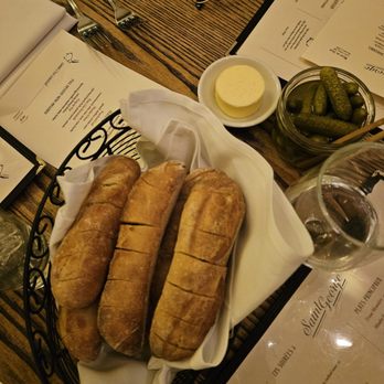 Saint George Bistro - Warm bread, cornichons, and butter, for the table - French Near Me - Hastings on Hudson, New York
