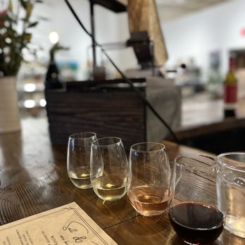 Salt & Bubbles - Wine flight with artisanal raclette in the background. - Wine Bars Near Me - Essex Junction, Vermont Salt & Bubbles - Wine flight with artisanal raclette in the background. - Wine Bars Near Me - Essex Junction, Vermont