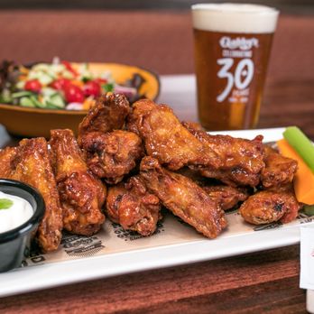 Gabby's Grill and Taps - Bloor West - a plate of wings and a bowl of salad - Bars Near Me - Toronto, Ontario Gabby's Grill and Taps - Bloor West - a plate of wings and a bowl of salad - Bars Near Me - Toronto, Ontario