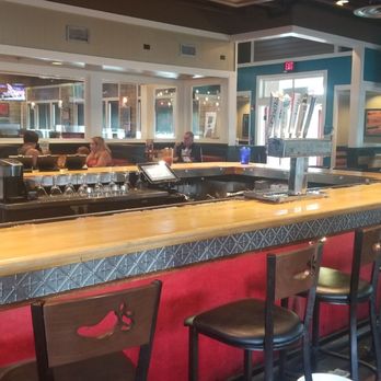 Chili's - a restaurant with a long bar with red seats - Bars Near Me - Olive Branch, Mississippi