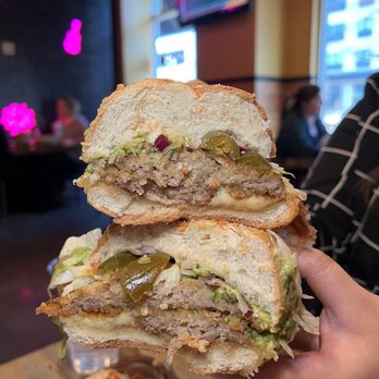 The Taco Shop - a person holding a sandwich - Mexican Near Me - Minneapolis, Minnesota The Taco Shop - a person holding a sandwich - Mexican Near Me - Minneapolis, Minnesota