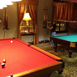 a pool table in the foreground a pool table in the foreground