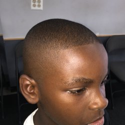Justice Cuts - High an tight bald fade with lined front.