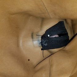 Interior, the zipper was sewn in with a fold at the top, making the end of the zipper protrude on the outside