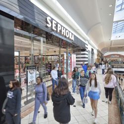 Shoppers walk past the Sephora storefront on the upper level of Crabtree Valley Mall.
