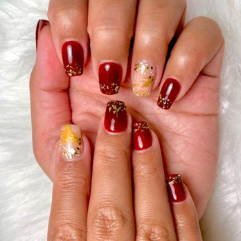 Oasis Nails - Hand painted goldfish and gold flake tips on dark red nails. Bella has a good eye for color - Nail Salons Near Me - Livermore, California Oasis Nails - Hand painted goldfish and gold flake tips on dark red nails. Bella has a good eye for color - Nail Salons Near Me - Livermore, California