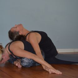 Island Yoga Health & Wellness - Tanya and Jaime doing a bit of partner yoga. Sometimes it is the support of a friend that helps get you just a bit further.