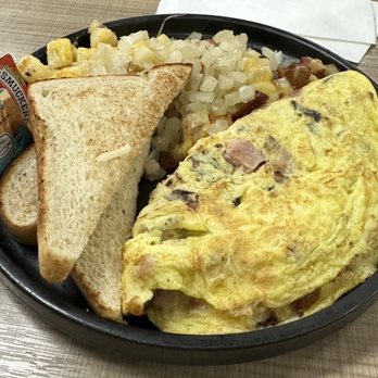 Rick's City Diner - Meat lovers omelette with sourdough bread, potatoes, (covered and smothered). - American Near Me - Toledo, Ohio