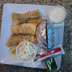 Hydeout Bar & Grill - Battered crunchy  fish with baked potato.  The coleslaw was delicious still crunchy not soaked in sauce.. my meal was just  perfect ...