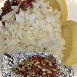 Chino Meat Market - Nice fresh garnishes provided for Menudo. Lemon, onions, oregano, red chilies. A must...
