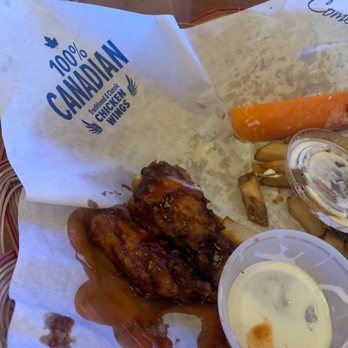 Wild Wings - a plate of food on a table - Chicken Wings Near Me - Brampton, Ontario Wild Wings - a plate of food on a table - Chicken Wings Near Me - Brampton, Ontario