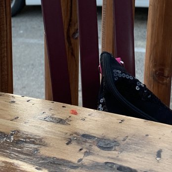 The Pizza Barn - Food on table and chairs with trash. Looked like the busboy wiped off the table and it landed on the seats. - Pizza Near Me - Kernville, California