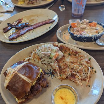 Snooze, an A.M. Eatery - Sandwich I AM (bottom), Sausage Gravy (Right), and bacon flight (Top Left). - Breakfast & Brunch Near Me - Westminster, Colorado