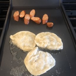 Heating up some kabanosy kielbasa and pierogies that I picked up earlier today.