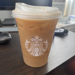 a cup of iced coffee on a desk