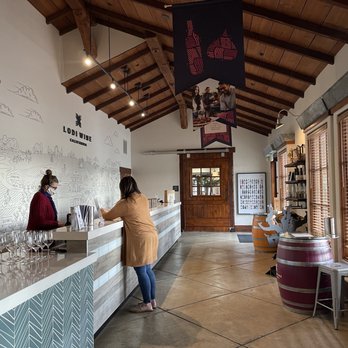 Lodi Wine Visitor Center - a woman standing at the counter - Wineries Near Me - Lodi, California Lodi Wine Visitor Center - a woman standing at the counter - Wineries Near Me - Lodi, California