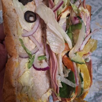 Subway - lone olive upper left, 1 wax pepper bottom right 2 leaves of spinach lower right - Sandwiches Near Me - Clovis, California
