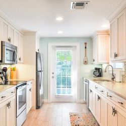 Lizzie Lus Island Retreat - The kitchen is located near the pool to ensure easy preparation and access to both the indoor and outdoor dining areas...