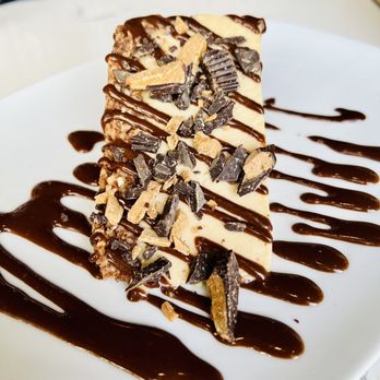 RÜT Bar & Kitchen - Captain Nutella crunch cake. Peanut butter cheesecake hazelnut crust Nutella drizzle peanut butter cup crumbles. - Vegan Near Me - Spokane, Washington RÜT Bar & Kitchen - Captain Nutella crunch cake. Peanut butter cheesecake hazelnut crust Nutella drizzle peanut butter cup crumbles. - Vegan Near Me - Spokane, Washington